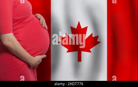 Pregnant woman belly on Canadian flag background Stock Photo