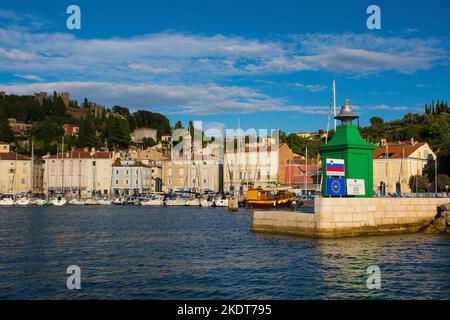 Piran, Slovenia - September 17th 2022. A small green lighthouse on the waterfront of the historic medieval town of Piran on the coast of Slovenia. Stock Photo