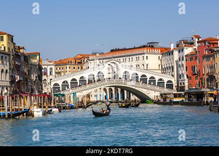 Venice, Italy - March 20, 2022: Rialto Bridge Rialto Bridge Over Canal Grand Canal With Gondola Vacation Travel Travel City In Venice, Italy. Stock Photo