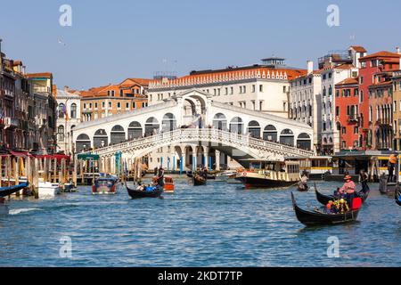 Venice, Italy - March 20, 2022: Rialto Bridge Rialto Bridge Over Canal Grand Canal With Gondola Vacation Travel Travel City In Venice, Italy. Stock Photo