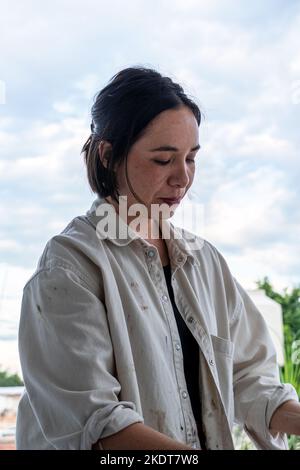 art workshop, messy objects, brushes, paint all mixed up disorganized, woman artist Stock Photo