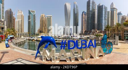 Dubai, United Arab Emirates - May 25, 2021: Dubai Marina Logo And Harbour Skyline Architecture Luxury Vacation In Arabia Panorama In Dubai, United Ara Stock Photo