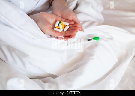Many pills and capsules in women in the hands Stock Photo