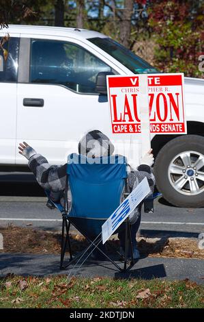 Mid Term Election Day - US -- A woman hold a sign in front of the polling station in Barnstable, Massachusetts, USA on Cape Cod Stock Photo