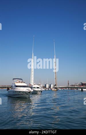 Motor boats in Poole Harbour with the Twin Sails Bridge beyond, Poole, Dorset, England, UK, September 2018 Stock Photo