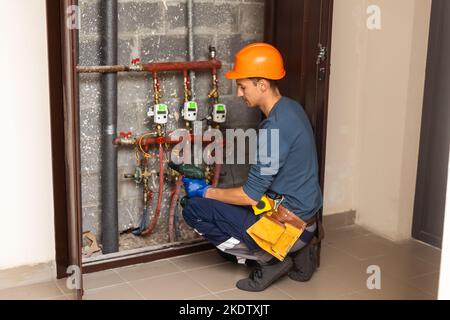 Technician inspecting heating system in boiler room Stock Photo