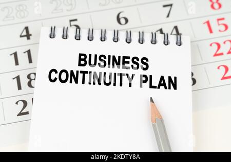 Business planning concept. On the calendar is a notebook with the inscription - BUSINESS CONTINUITY PLAN Stock Photo