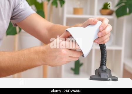 The man changes the lamp. Energy-saving lamp. Replacement of an energy-saving lamp. Stock Photo