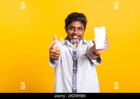 black man smile showing a mobile smartphone blank screen and finger thumb up Stock Photo
