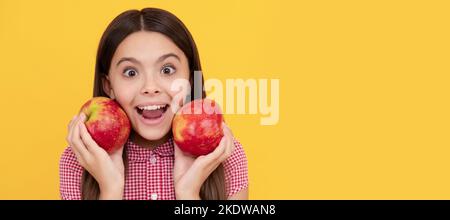 surprised kid hold healthy apple fruit with vitamin. Child girl portrait with apple, horizontal poster. Banner header with copy space. Stock Photo