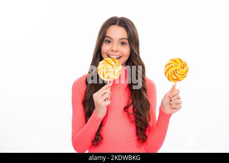 Teenage girl with candy lollipop, happy child 12, 13, 14 years old eating big sugar lollipop, sweets candy. Happy girl face, positive and smiling Stock Photo