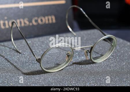 A pair of photo-matched round wire-rimmed gold-tone glasses owned and worn by John Lennon on display in Hard Rock Cafe Times Square on November 08, 20 Stock Photo