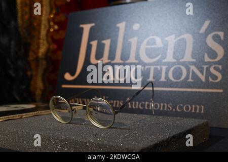 A pair of photo-matched round wire-rimmed gold-tone glasses owned and worn by John Lennon on display in Hard Rock Cafe Times Square on November 08, 20 Stock Photo