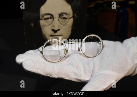 A pair of photo-matched round wire-rimmed gold-tone glasses owned and worn by John Lennon on display in Hard Rock Cafe Times Square on November 08, 20 Stock Photo