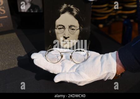 A pair of photo-matched round wire-rimmed gold-tone glasses owned and worn by John Lennon on display in Hard Rock Cafe Times Square on November 08, 20 Stock Photo