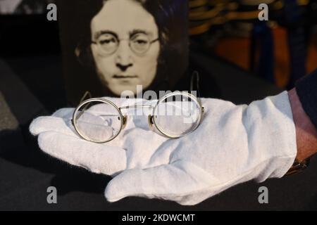 A pair of photo-matched round wire-rimmed gold-tone glasses owned and worn by John Lennon on display in Hard Rock Cafe Times Square on November 08, 20 Stock Photo