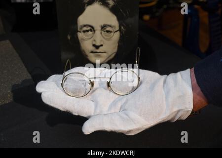 A pair of photo-matched round wire-rimmed gold-tone glasses owned and worn by John Lennon on display in Hard Rock Cafe Times Square on November 08, 20 Stock Photo