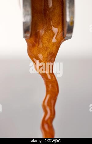 pouring fresh espresso coffee from coffee machine, macro, selective focus Stock Photo