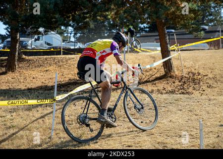 WA22605-00...WASHINGTON - Tom Kirkendall riding up a short but steep hill, part of a cyclocross race at Evergreen High School in Seattle. Stock Photo