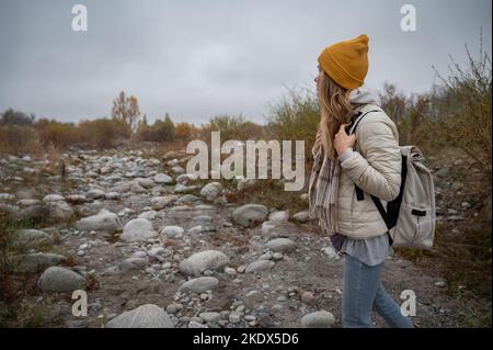 Slow and not deep mountain river with rounded stones Stock Photo