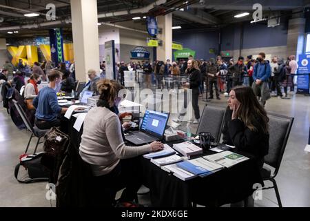 Seattle, Washington, USA. 8th November, 2022. King County Elections staff members and volunteers verify registration and register new voters as hundreds wait in line at the Lumen Field vote center in Seattle on Tuesday November 8, 2022. Credit: Paul Christian Gordon/Alamy Live News Stock Photo