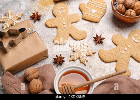 Tasty Christmas cookies, gift, walnuts and honey on light background, closeup Stock Photo