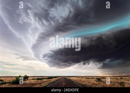 Dramatic storm clouds over a road near Fort Sumner, New Mexico Stock Photo
