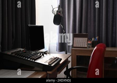 Home studio interior with professional condenser microphone and blank screen computer. Podcasts and technology concept Stock Photo