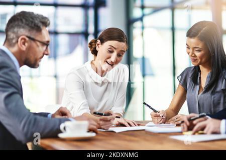 Getting down to business in the office. a group of colleagues working together in an office. Stock Photo