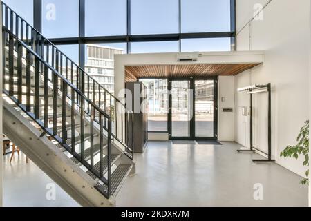 stairs in a light modern entrance building with big windows Stock Photo