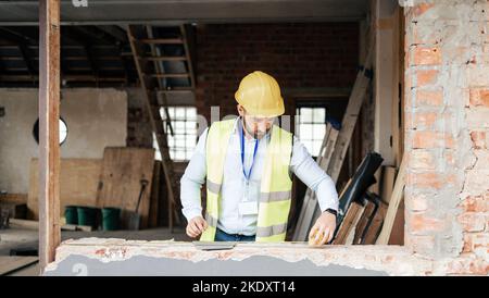 Construction, building manager man and handyman contractor measure on architect project. Industrial, engineer or construction worker planning and Stock Photo
