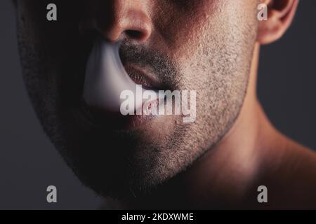 Smoke, black man and face marijuana with cancer awareness and with bad habit with black studio background. Addiction, mouth with smoking cloud and Stock Photo