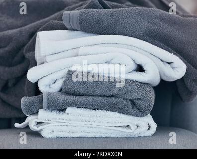 Towels, clean and laundry with texture and fabric for cleaning and hygiene in hospitality or home. Fresh washing, cleaning service or household Stock Photo
