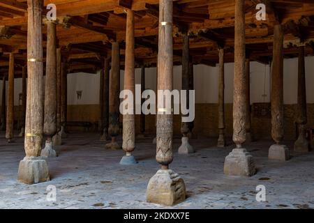 Ancient carved wooden columns in the medieval Juma mosque. Khiva, Uzbekistan Stock Photo