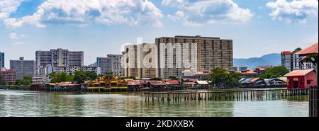 George Town, Penang, Malaysia - March 2018: Overlooked by modern apartment buildings are some of the Clan Jetties alongside the Hean Boo Thean Temple, Stock Photo