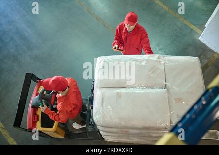 Two storehouse workers preparing freight for shipping Stock Photo