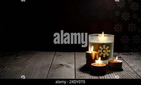 Christmas theme celebration with candles on dark wooden table view with copy space. Stock Photo