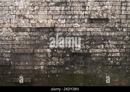Balinese brick wall texture, stained moss brick wall, irregular pattern, protruding bricks, Stock Photo