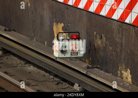 A NYC subway third rail warning device. The safety device activates flashing lights and a siren if the 3rd rail becomes energized. Stock Photo