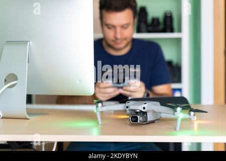 Filmmaker in his home office with his drone on his desk Stock Photo