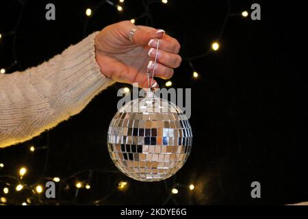 Woman's hands holding shiny ball Stock Photo