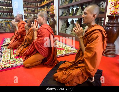 Buddhist monks pray at a shrine within Phnom Preah Reach Troap at Oudong Temple in Kandal Province near Phnom Penh, Cambodia. Stock Photo