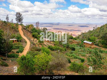 Village houses and track high in the Sagalla Hills overlooking the Ndara Plain near Voi in Kenya Stock Photo