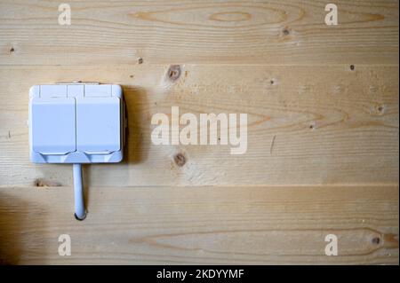 double electrical outlet on wooden wall in workshop Stock Photo