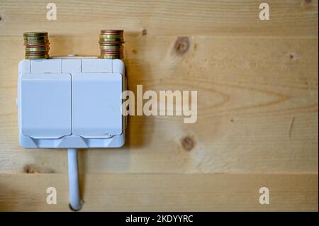 stacks of coins standing on electrical outlets in workshop Stock Photo