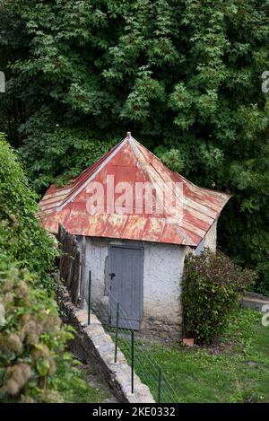 Old Garden Shed or Hut with Pointed Red Corrugated Iron Roof Seyne-les-Alpes Alpes-de-Haute-Provence Provence France Stock Photo