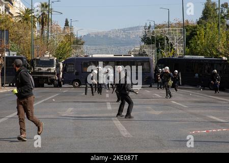 Athen, Greece. 09th Nov, 2022. A demonstrator throws a stone at riot police officers during a 24-hour general strike in Athens. Major Greek trade unions have called for a nationwide 24-hour strike. Credit: Socrates Baltagiannis/dpa/Alamy Live News Stock Photo