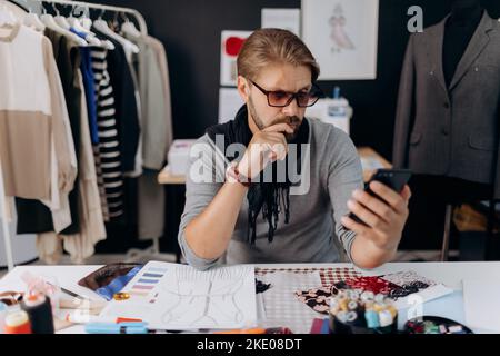 Designer using smartphone Stock Photo