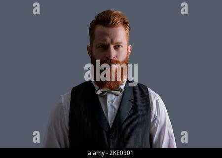Portrait of barber with unshaven face. Redhead barber with bowtie. Bearded Irish man with beard Stock Photo
