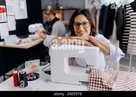 Female designer using sewing machine Stock Photo